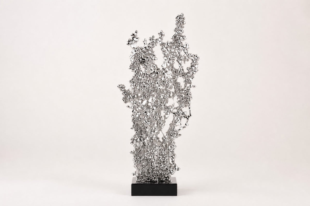 Kessho — silver crystal-cluster sculpture growing upward like frosted coral, studio front view