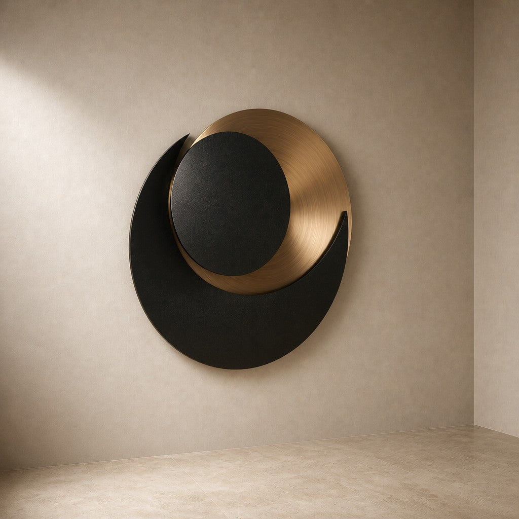 Black and warm gold bronze wall sculpture Kusuf, a matte disc overlapping a gilded crescent, on a plaster wall.