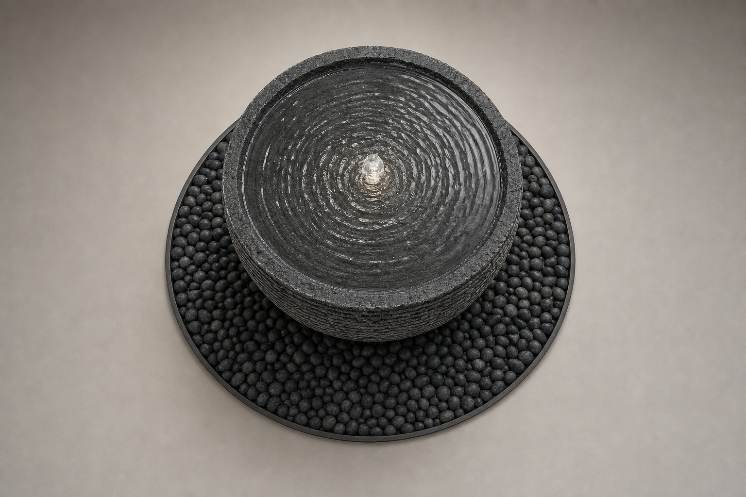 Lagoa charcoal stone bowl fountain by 1-OPH, overhead view of the still surface