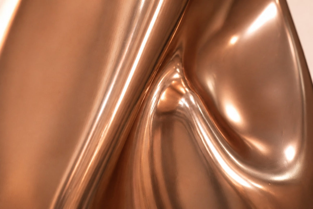 Lahab — 60 cm mirror-polished copper ovoid sculpture with a deep flame-like fold, close studio detail of the surface and material