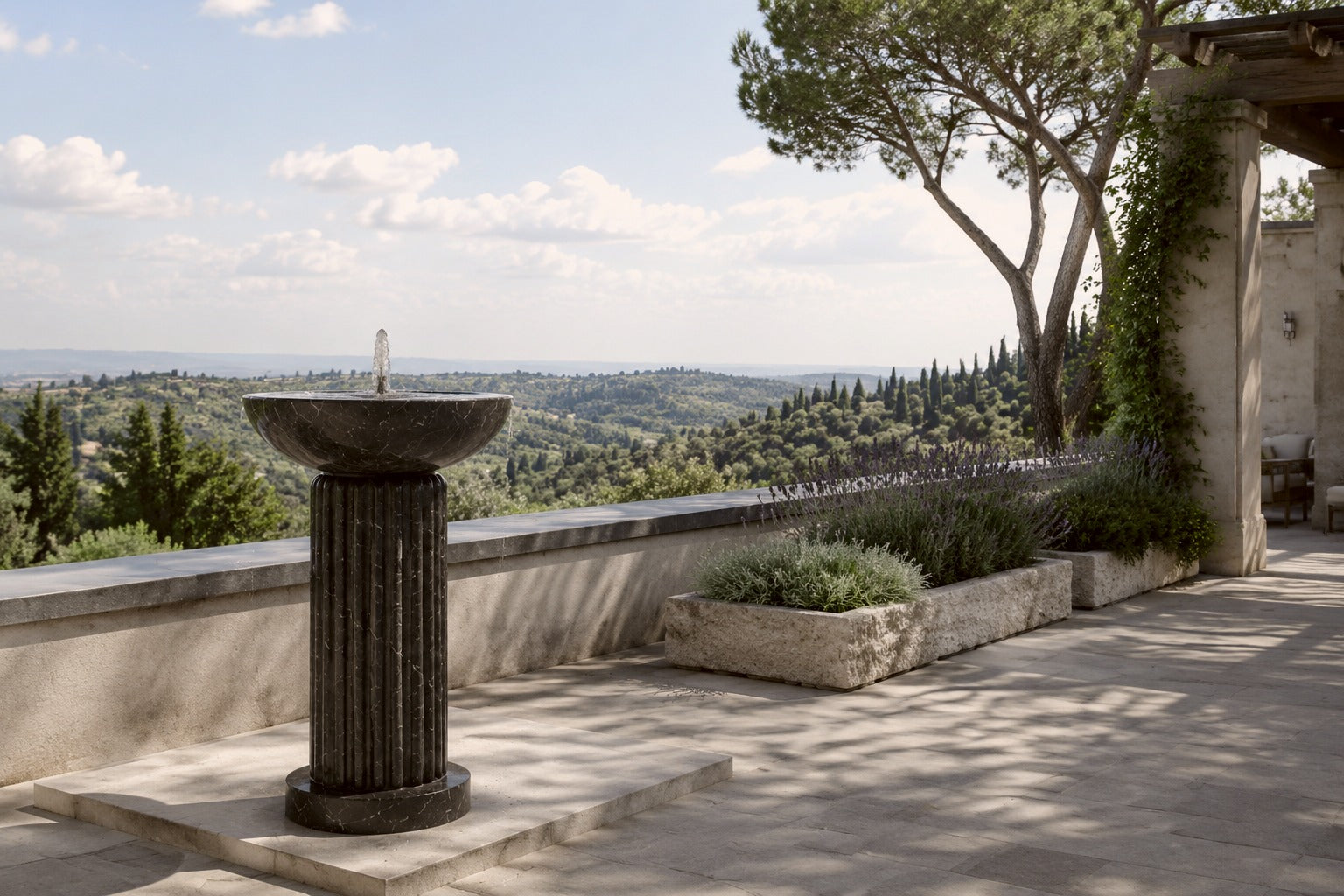 Dark marble pedestal fountain Layla Ø65, deep black with white veining, on a pale stone floor.