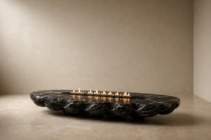 Black marble with white veining fire table Laylan 220, deep black with white and gold veining, on a pale stone floor.