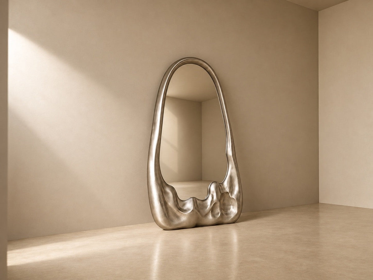 Lucidez — 110 × 200 cm tall standing mirror with a brushed stainless steel frame melting at the base, three-quarter studio view showing its profile