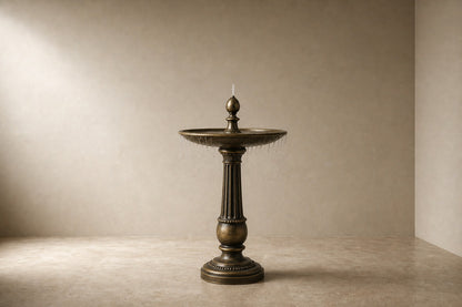 Stone pedestal fountain Lumara Ø65, antique bronze with olive depths, on a pale stone floor.