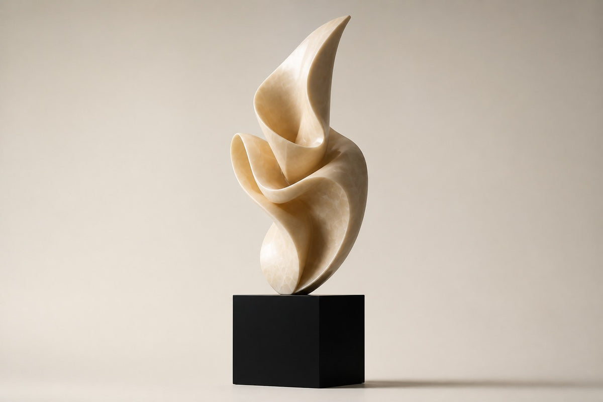 LUMEN VEIL — pale cream marble abstract sculpture on a black cube plinth, studio side angle showing its depth
