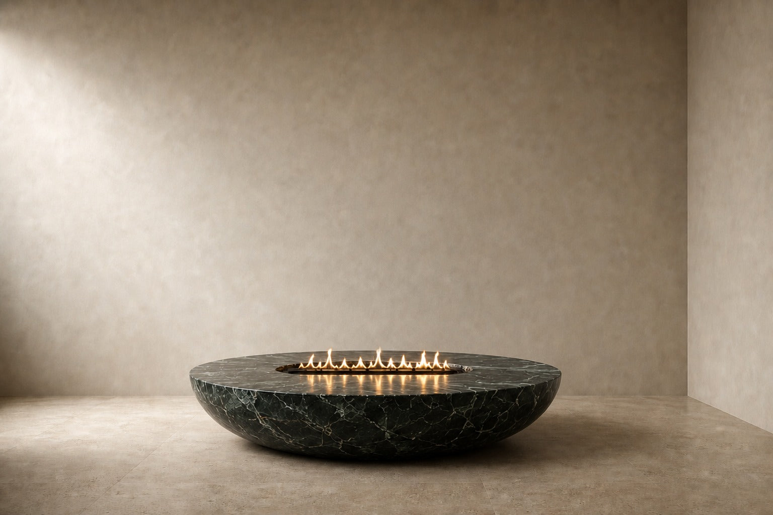 Dark green-black marble fire bowl Mayura Ø180, dark green-black with white veining, on a pale stone floor.