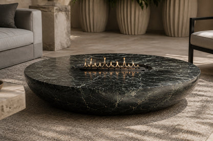 Dark green-black marble fire bowl Mayura Ø180, dark green-black with white veining, on a pale stone floor.