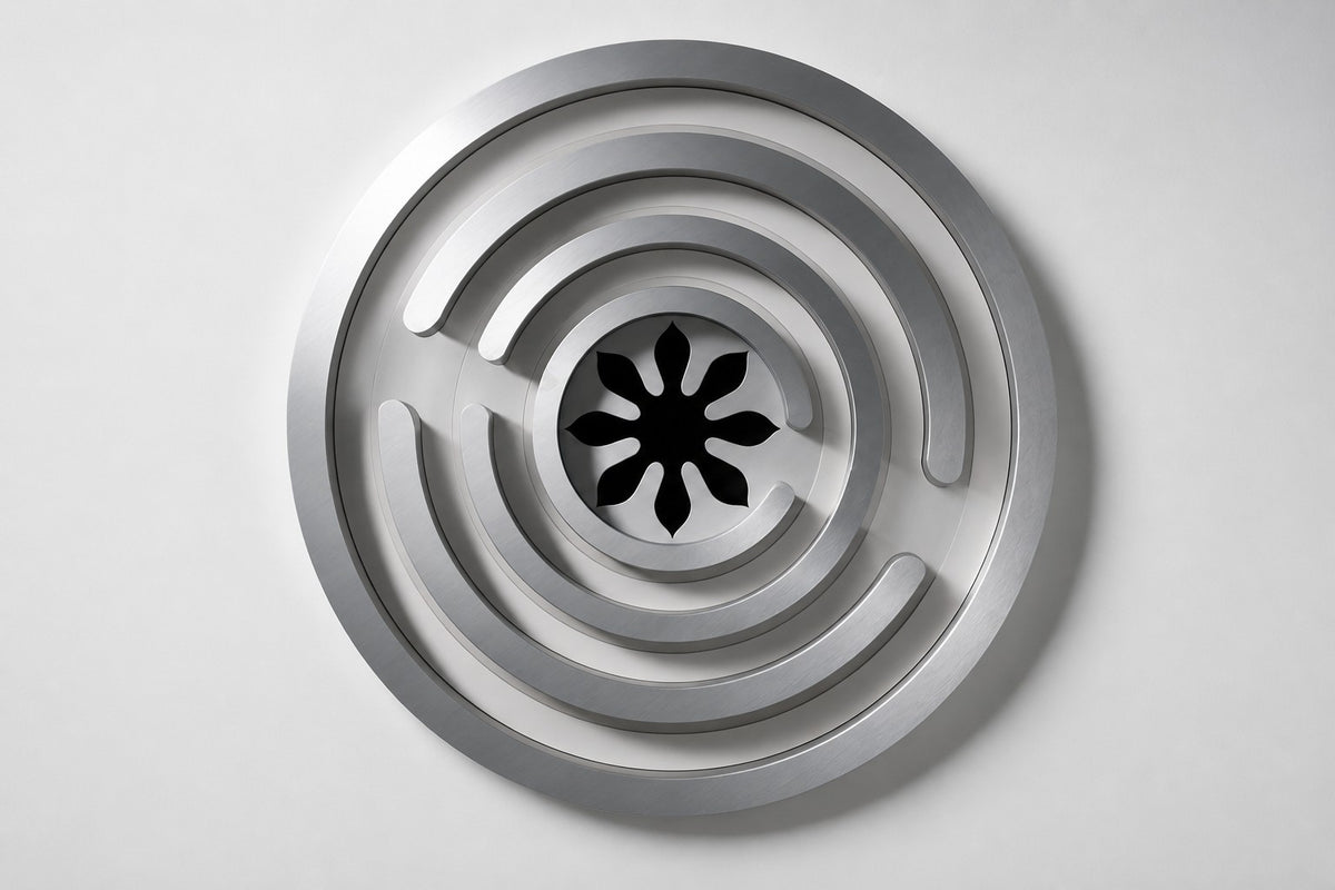 Meandro — Ø 200 cm brushed stainless steel circular wall relief with a labyrinth of arcs, studio front view