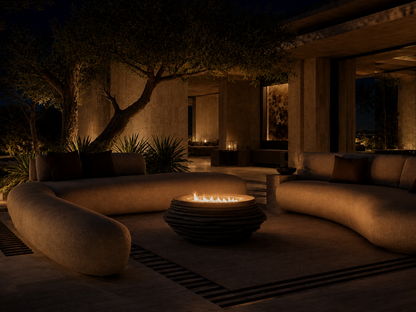 Caldera black stone fireplace by 1-OPH lit at night