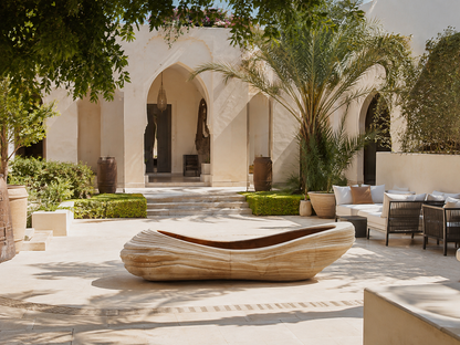 Arenara beige stone fireplace by 1-OPH in a Dubai terrace setting