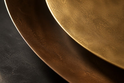 Gunmetal steel wall sculpture Asse, slender rods bundled along a single horizontal spine, on a plaster wall.