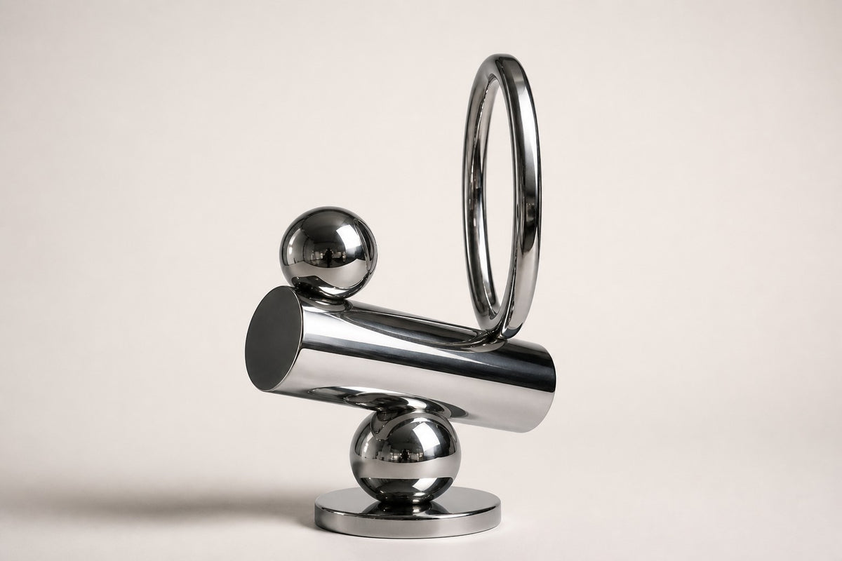 Mintaka — mirror chrome balancing ring and cylinder sculpture, studio side angle showing its depth