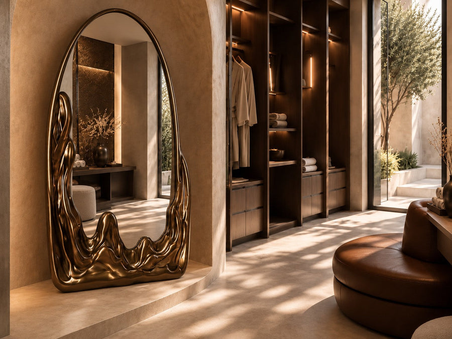 Miraggio — 110 × 200 cm tall arched standing mirror with a dark bronze frame melting at the base, placed in a furnished room