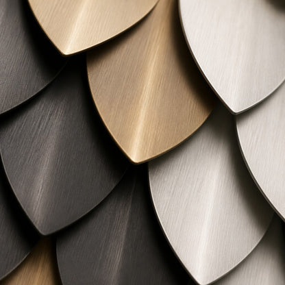 Brass and graphite brass wall sculpture Bilancia, two spun discs set to counterweight across a turned pivot, on a plaster wall.