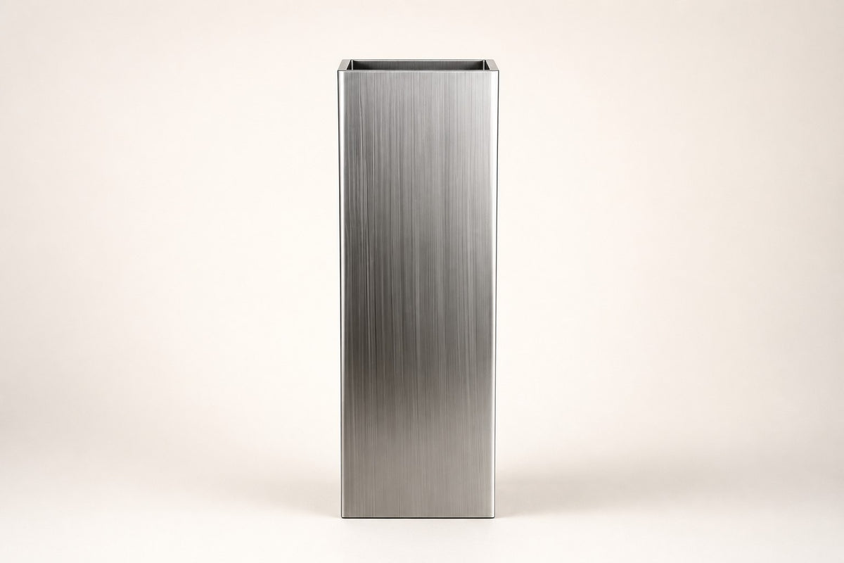 Monolith Brushed Stainless Steel Column Planter — 140 cm slim brushed stainless steel column planter with a trailing plant, studio view of the whole piece