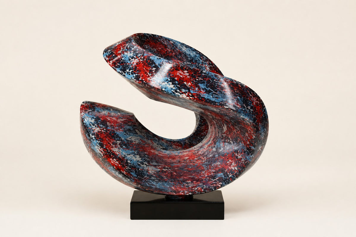 Muyu — red and blue marbled swirl sculpture on a black base, studio front view