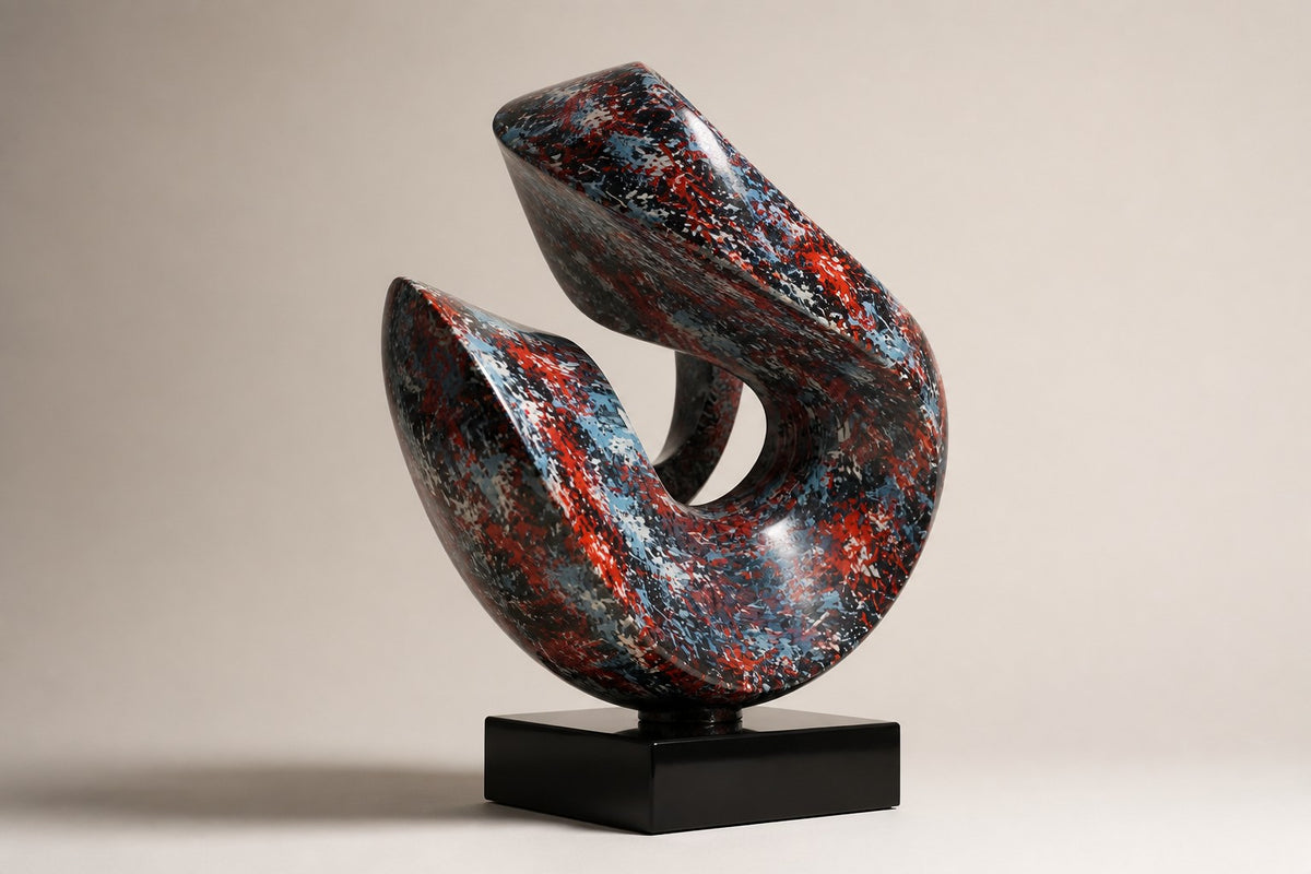 Muyu — red and blue marbled swirl sculpture on a black base, studio side angle showing its depth