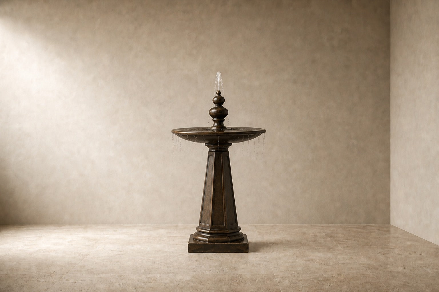 Stone pedestal fountain Namika Ø65, warm mottled brown, on a pale stone floor.