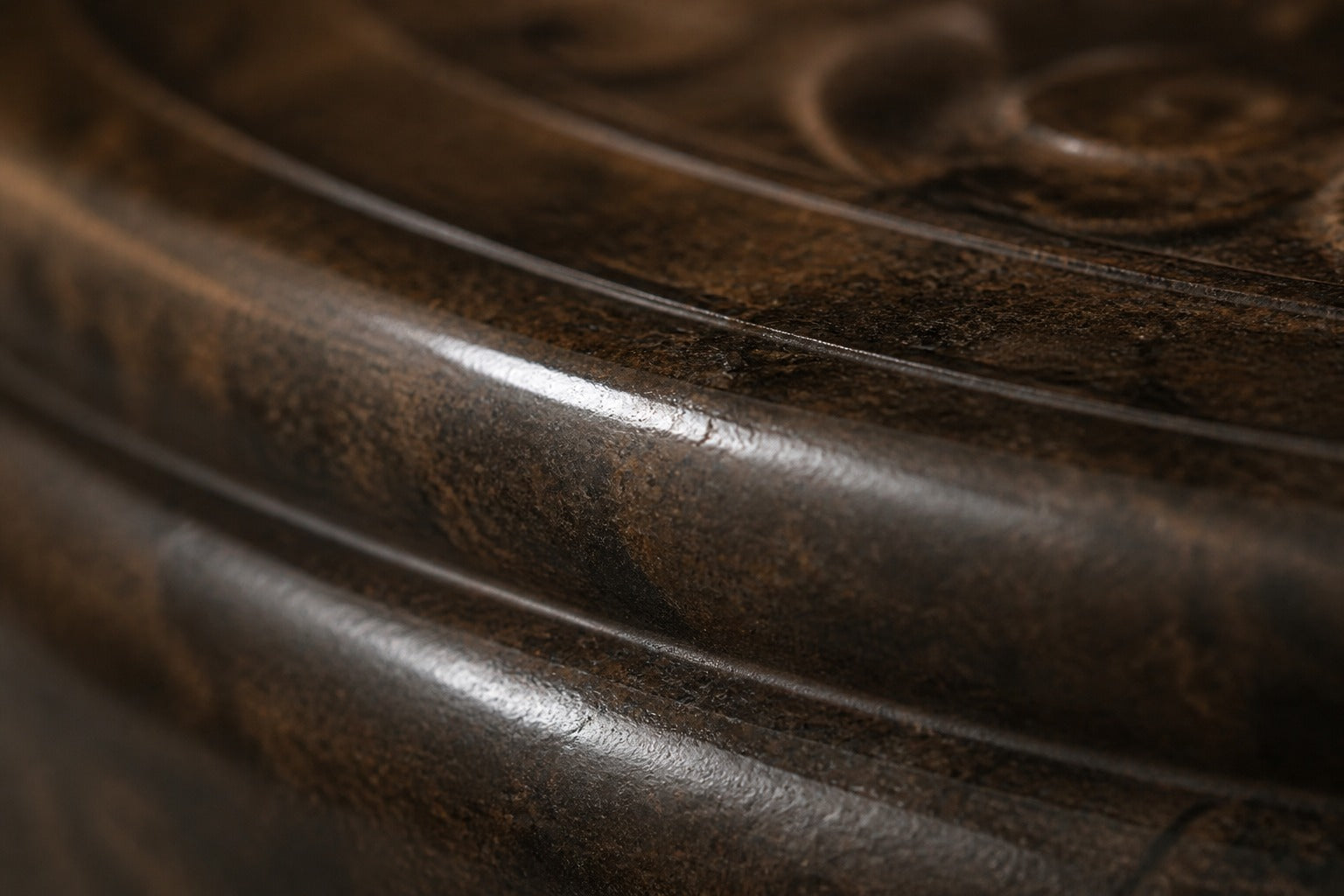 Stone pedestal fountain Namika Ø65, warm mottled brown, on a pale stone floor.