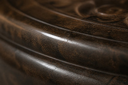 Stone pedestal fountain Namika Ø65, warm mottled brown, on a pale stone floor.