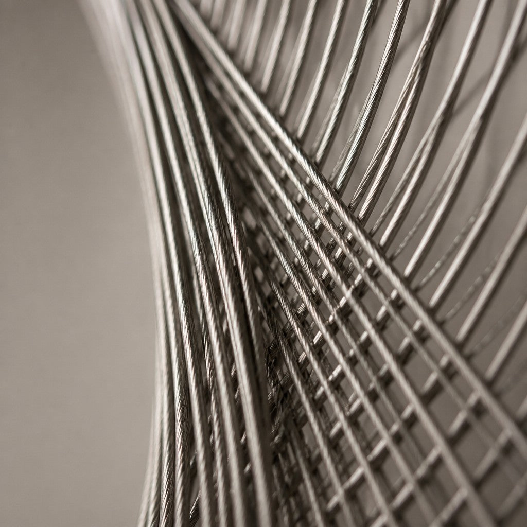 Nasij — 120 × 120 cm round brushed steel wire wall sculpture with a teardrop opening, close studio detail of the surface and material