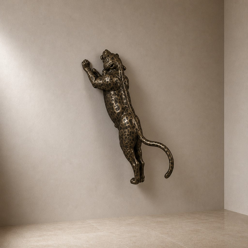Nimr 40 — 40 cm dark bronze wall sculpture of a spotted leopard climbing the wall, three-quarter studio view showing its profile