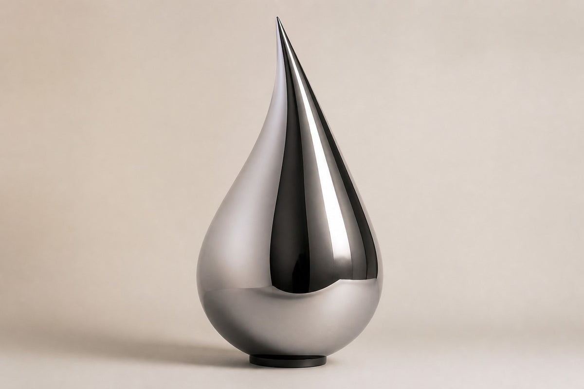Nuqta — 170 cm mirror-polished steel teardrop sculpture on a small dark base, three-quarter studio view showing its profile