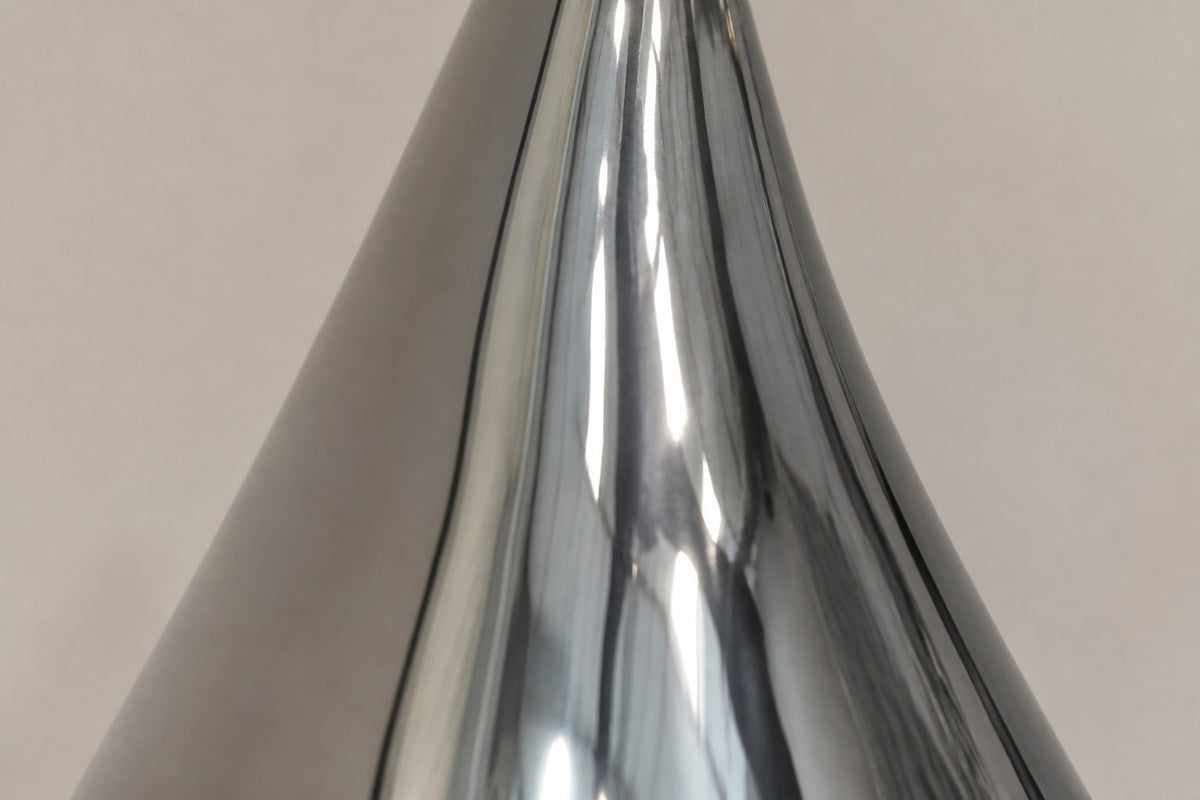 Nuqta — 170 cm mirror-polished steel teardrop sculpture on a small dark base, close studio detail of the surface and material