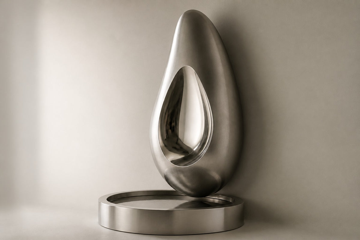 Nyra — stainless seed wall fountain, studio side angle showing its depth