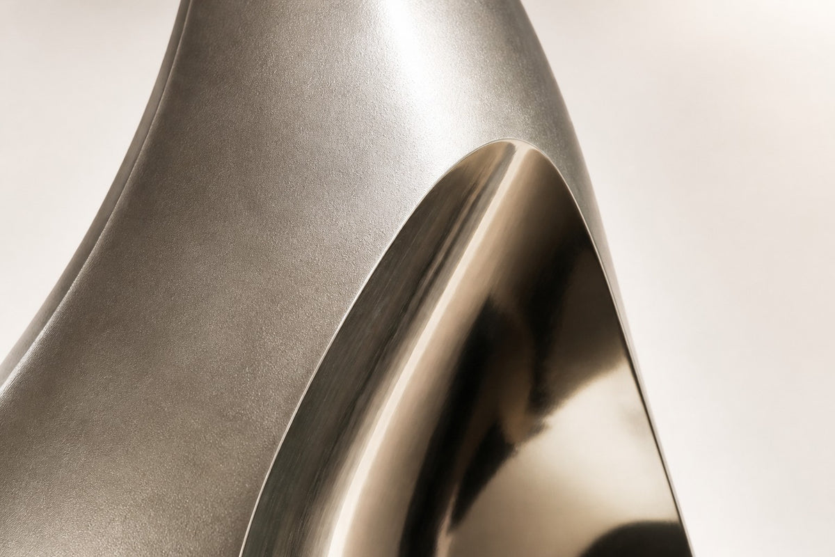 Nyra — stainless seed wall fountain, close detail of the surface and edge