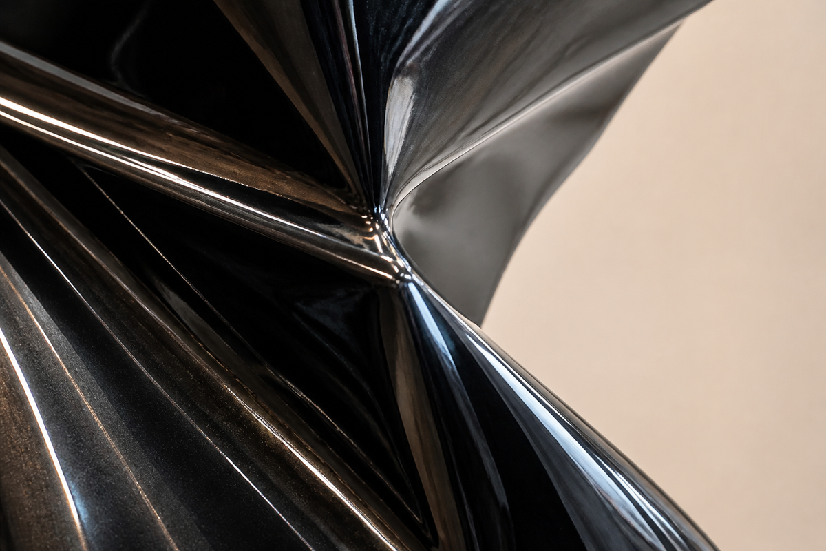OBSIDIAN FOLD stainless steel sculpture, close studio detail of the surface and material
