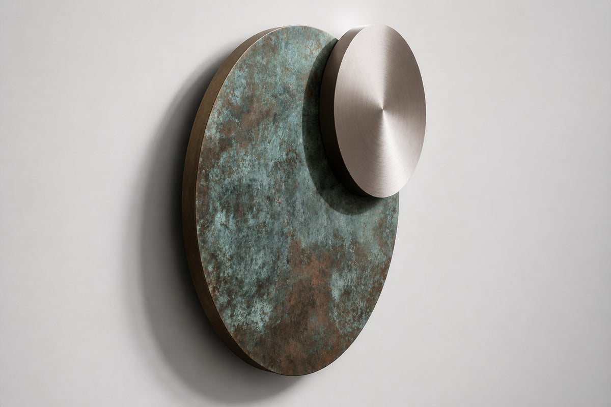 Ocaso — Ø 200 cm verdigris bronze and satin steel eclipse wall sculpture, studio side angle showing its depth