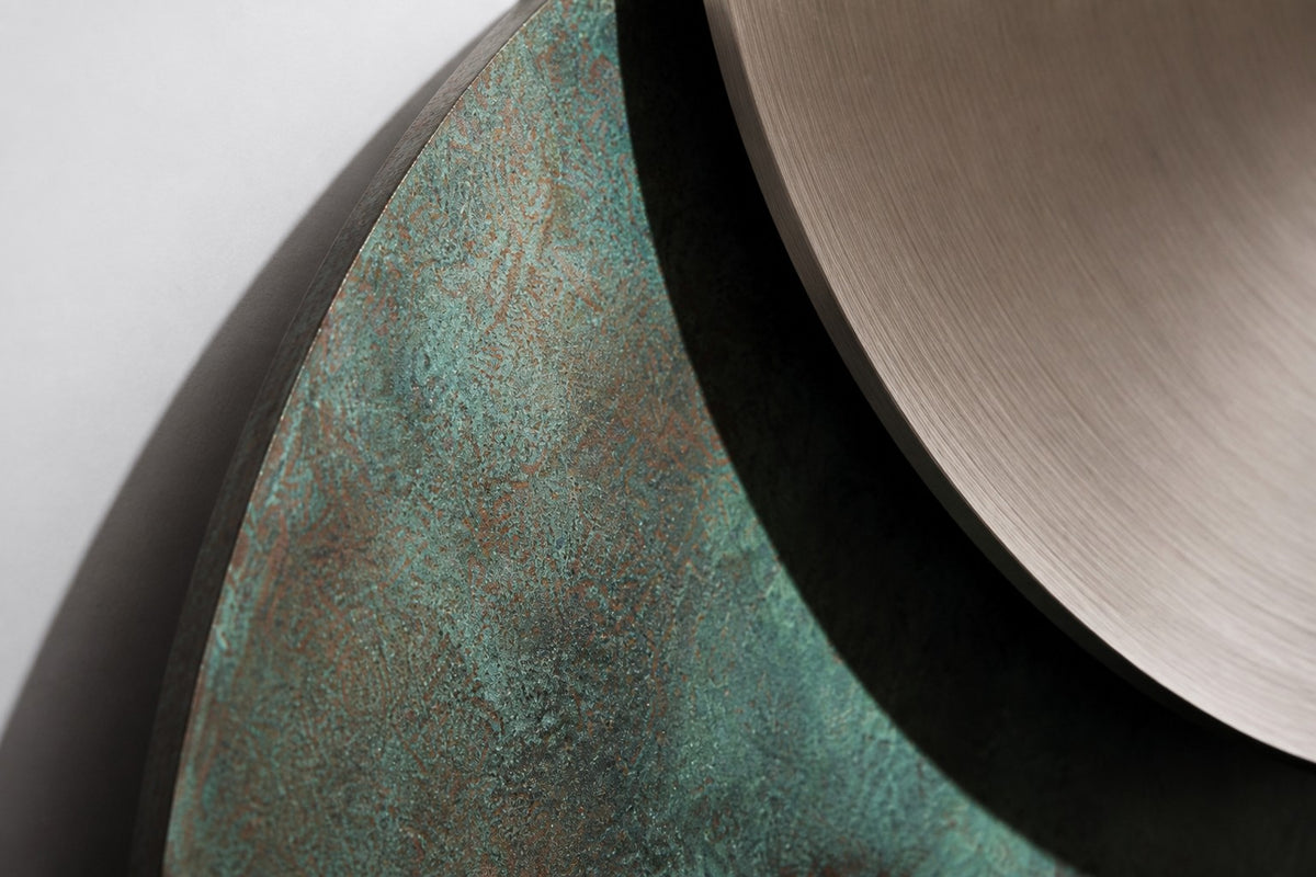 Ocaso — Ø 200 cm verdigris bronze and satin steel eclipse wall sculpture, close detail of the surface and edge