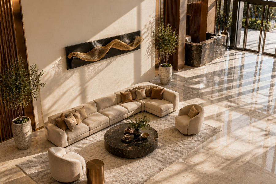 Oleaje — dark bronze wave plate crossed by a band of brass mesh, seen from above in the room