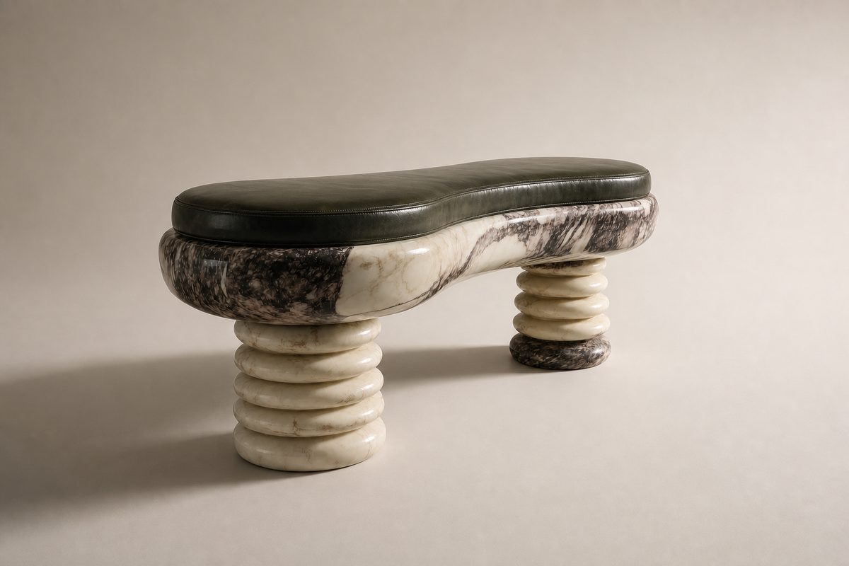 Ozio marble sculptural bench, three-quarter studio view showing its profile