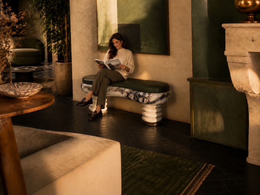 Ozio marble sculptural bench, shown in a room setting, at full scale