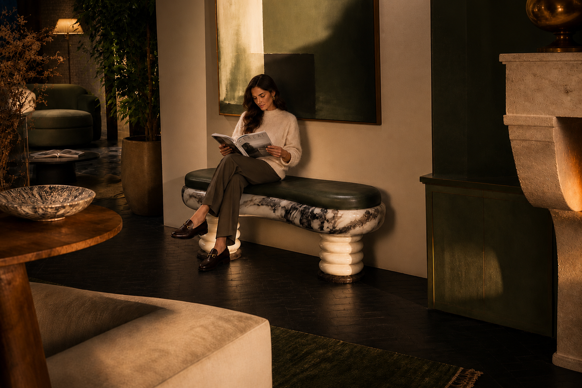 Ozio marble sculptural bench, in a room setting under evening light