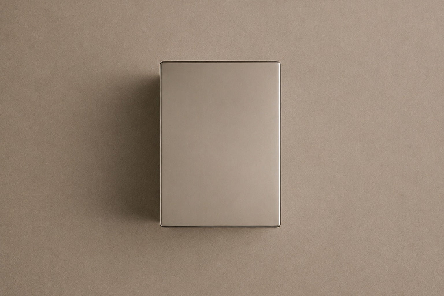 Tall mirror-polished stainless steel pedestal with a nose and mouth formed seamlessly out of one face.