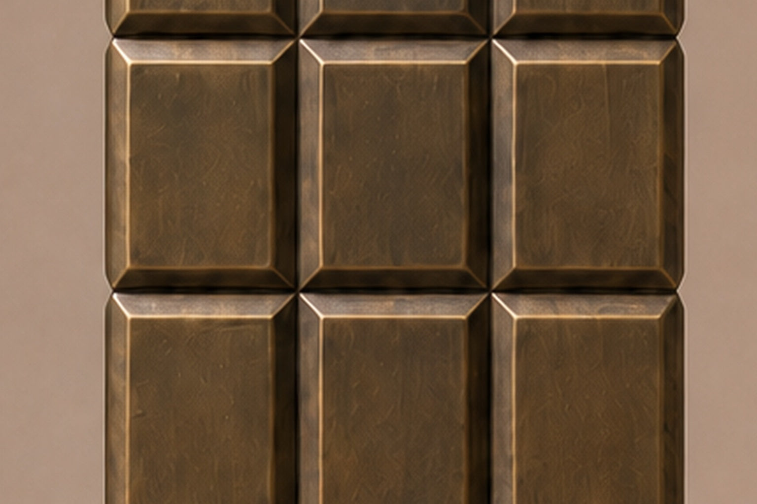 Tall antique bronze column built as a grid of raised cushioned panels.