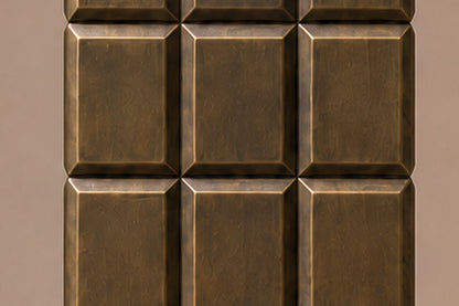 Tall antique bronze column built as a grid of raised cushioned panels.