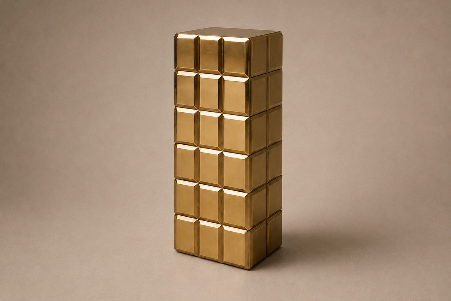 Tall polished brass column built as a grid of raised cushioned panels.