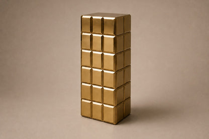 Tall polished brass column built as a grid of raised cushioned panels.