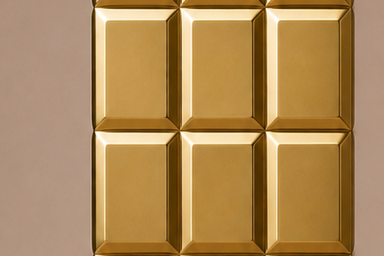 Tall polished brass column built as a grid of raised cushioned panels.