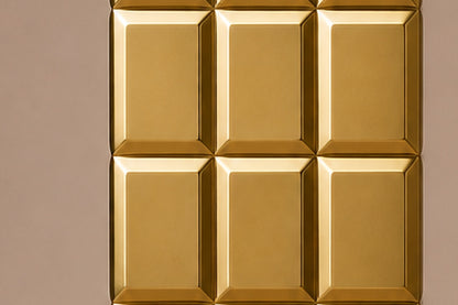 Tall polished brass column built as a grid of raised cushioned panels.