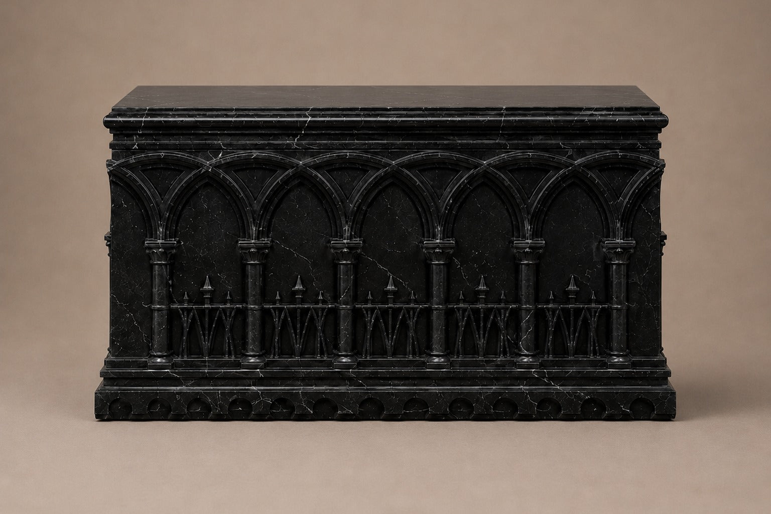 Low wide black Nero Marquina marble base carved with an arcade of pointed Gothic arches on colonnettes.