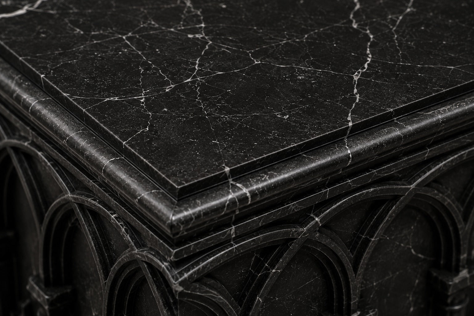 Low wide black Nero Marquina marble base carved with an arcade of pointed Gothic arches on colonnettes.