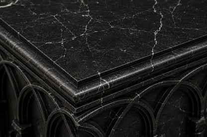 Low wide black Nero Marquina marble base carved with an arcade of pointed Gothic arches on colonnettes.