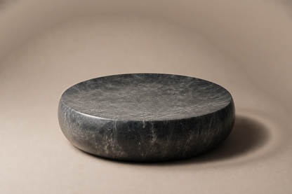 Convex Pillow Base Round black marble plinth base by 1-OPH, three-quarter studio view