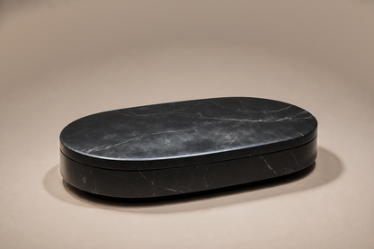 Oval Plinth Base Narrow black marble plinth base by 1-OPH, three-quarter studio view