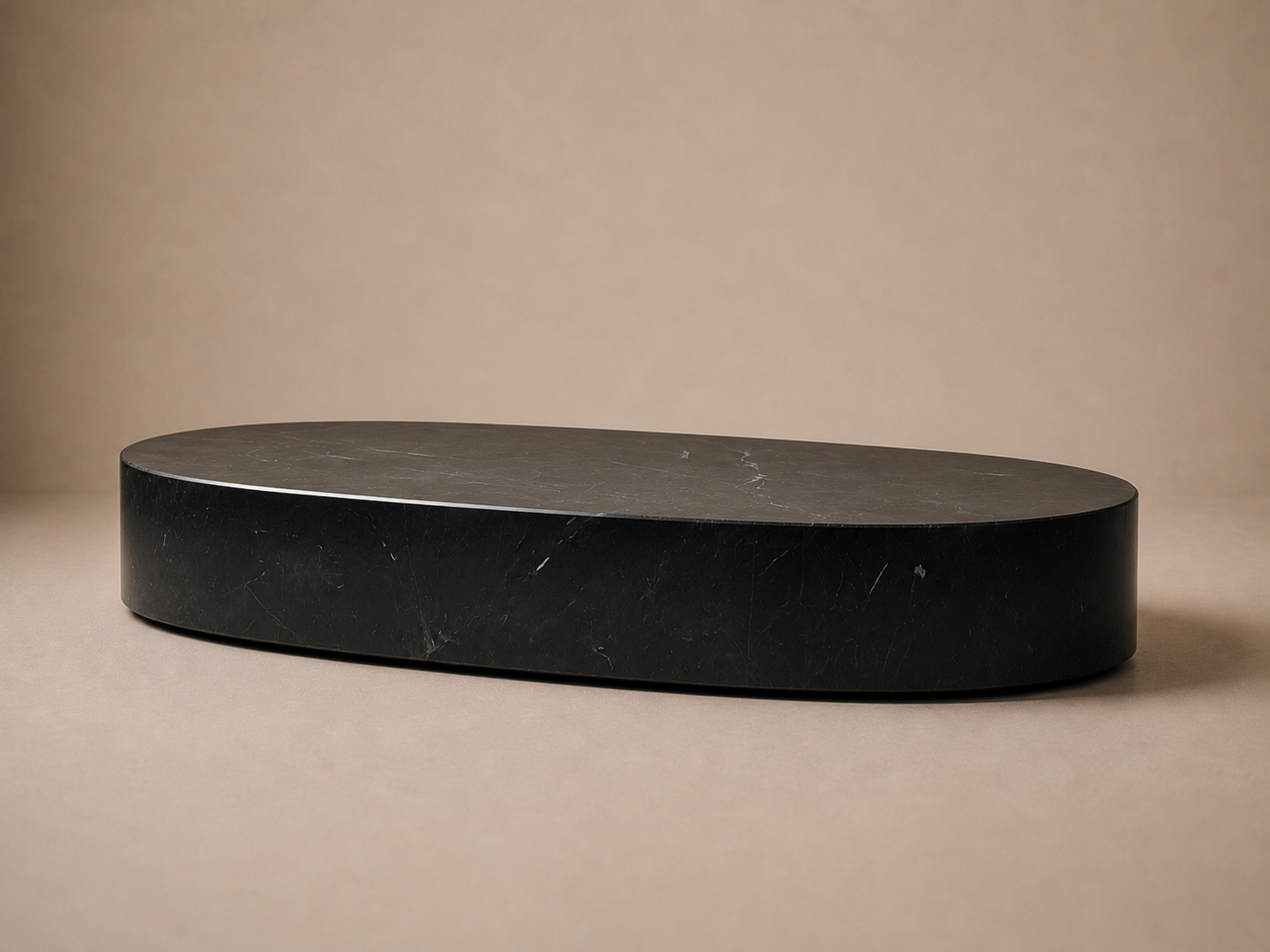Oval Plinth Base Low black marble plinth base by 1-OPH, three-quarter studio view